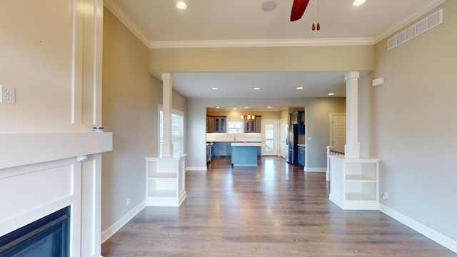 5492 Diversey Rdg, Columbia, MO 65203 - unfurnished living room with a ceiling fan, decorative columns, dark wood-type flooring, crown molding, and a fireplace