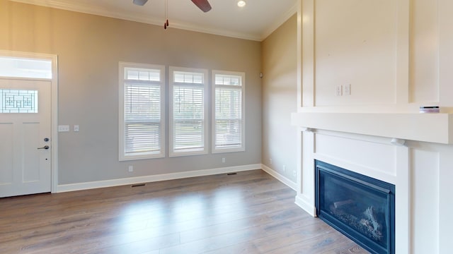 5492 Diversey Rdg, Columbia, MO 65203 - unfurnished living room with ornamental molding, a ceiling fan, wood finished floors, and a glass covered fireplace