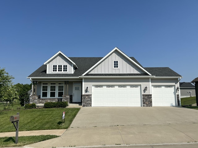 5492 Diversey Rdg, Columbia, MO 65203 - craftsman-style house with an attached garage, a front yard, concrete driveway, stone siding, and board and batten siding
