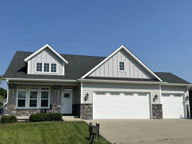 5492 Diversey Rdg, Columbia, MO 65203 - craftsman-style house with an attached garage, stone siding, board and batten siding, and concrete driveway