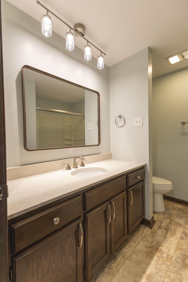 full bathroom featuring vanity, toilet, and an enclosed shower