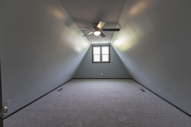 bonus room with ceiling fan, carpet, lofted ceiling, and baseboards