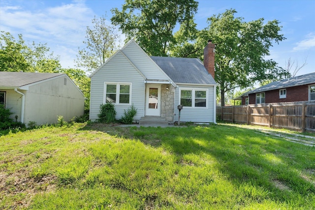 rear view of property featuring a chimney and entry steps