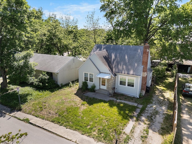 view of front of property featuring a chimney, dirt driveway, a front lawn, and entry steps