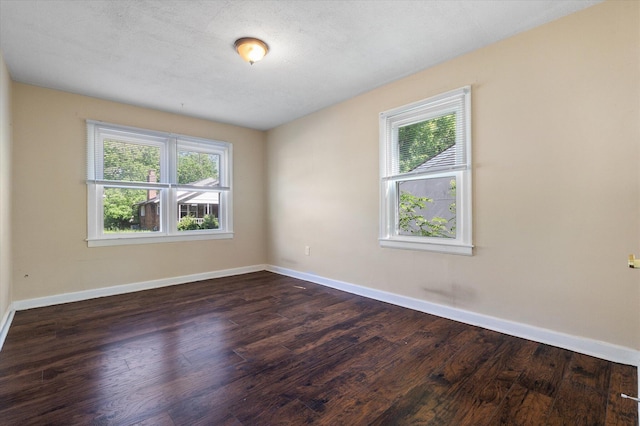 empty room with wood finished floors and baseboards