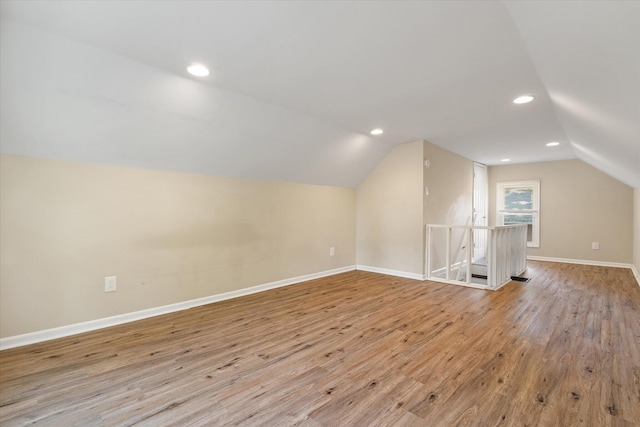 bonus room featuring lofted ceiling, light wood finished floors, baseboards, and recessed lighting
