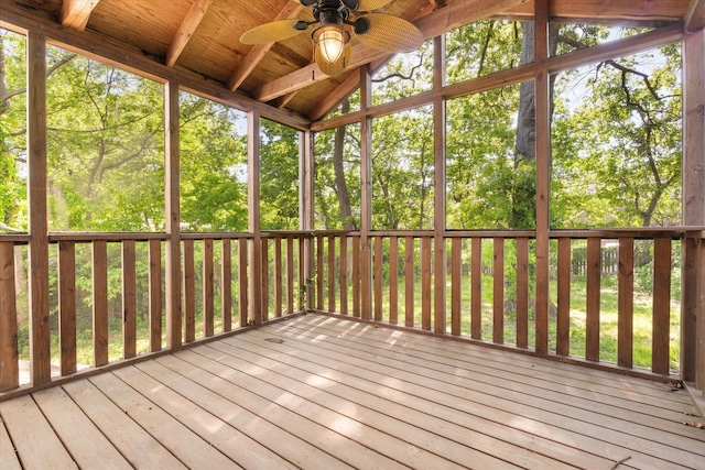 unfurnished sunroom with a ceiling fan and vaulted ceiling