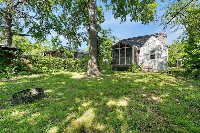 view of green lawn with a sunroom