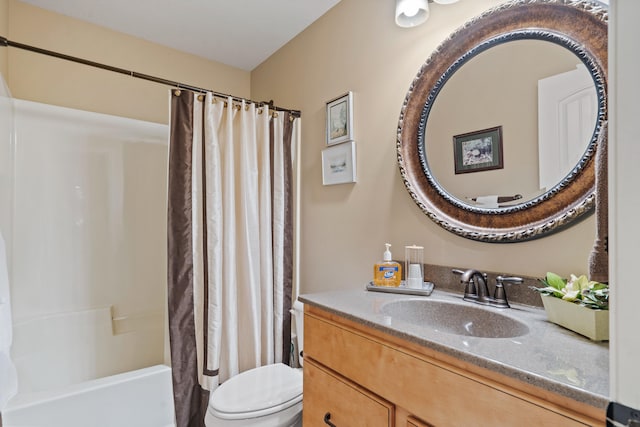bathroom featuring toilet, vanity, and shower / tub combo