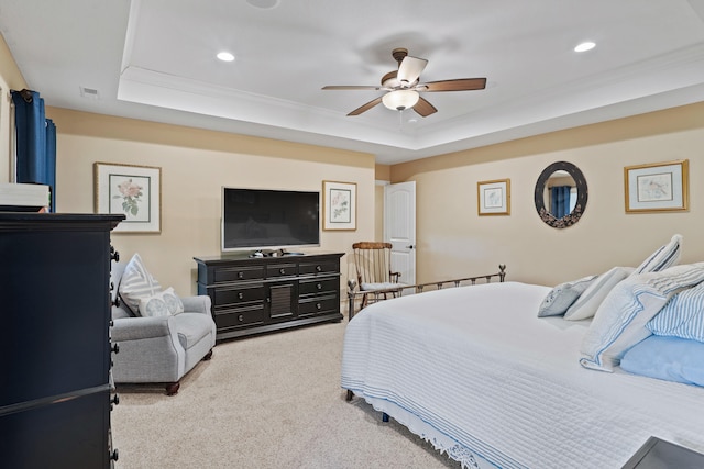 carpeted bedroom with a raised ceiling, recessed lighting, ceiling fan, and crown molding
