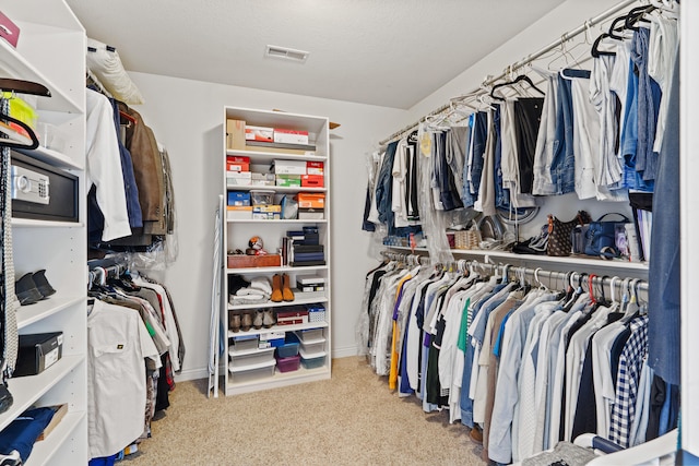 walk in closet featuring carpet flooring