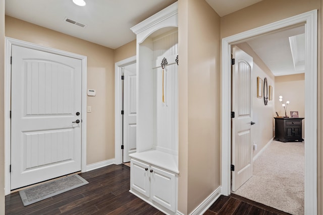mudroom featuring dark wood-style flooring and baseboards