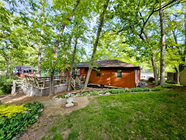 back of property featuring a wooden deck and fence