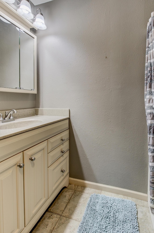bathroom featuring vanity and baseboards