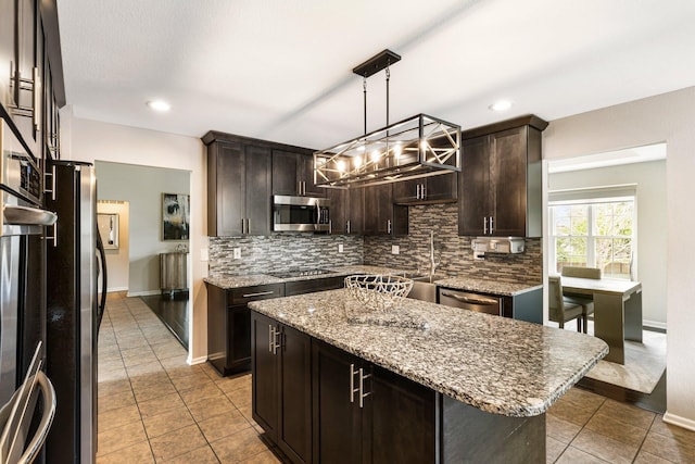 kitchen with appliances with stainless steel finishes, tasteful backsplash, tile patterned flooring, dark brown cabinetry, and recessed lighting