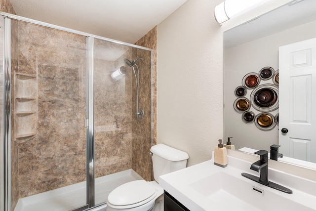 full bathroom with a shower stall, toilet, and vanity