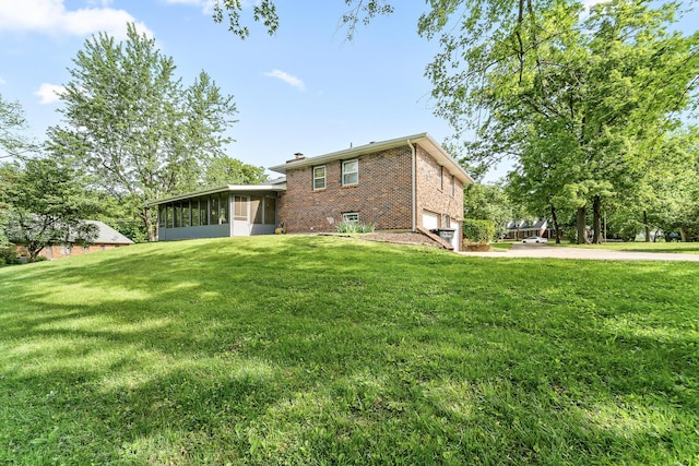 4 Halley Ct, Fulton, MO 65251 - rear view of property with a sunroom, brick siding, a lawn, a chimney, and concrete driveway