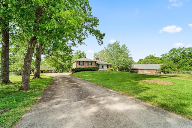 4 Halley Ct, Fulton, MO 65251 - view of front of home featuring a front yard, driveway, and brick siding