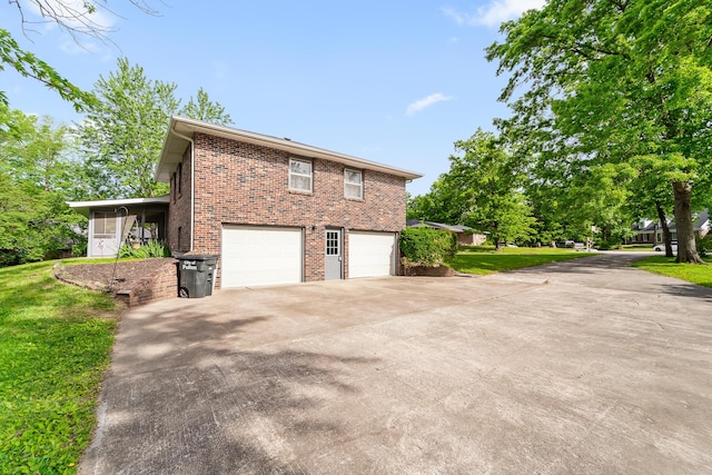 4 Halley Ct, Fulton, MO 65251 - view of home's exterior with brick siding, driveway, an attached garage, a yard, and a sunroom