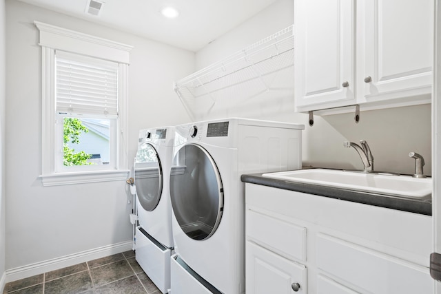 laundry room with separate washer and dryer, baseboards, and cabinet space