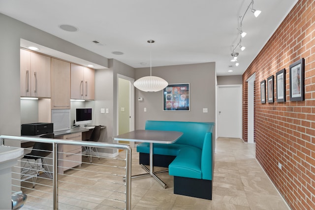kitchen with brick wall and pendant lighting