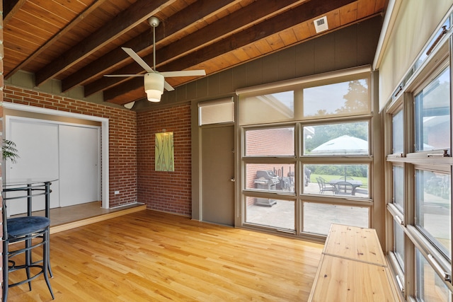 unfurnished sunroom with beamed ceiling and healthy amount of natural light