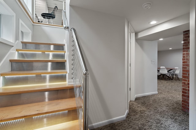 stairs with carpet, baseboards, and recessed lighting