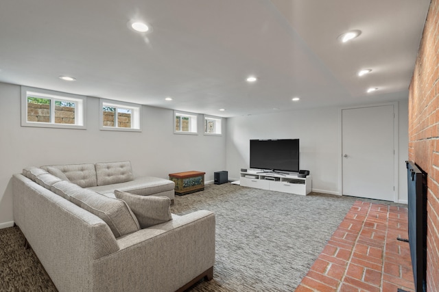 living room with recessed lighting, brick flooring, plenty of natural light, and baseboards