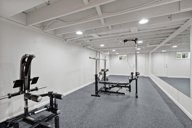 workout room featuring baseboards and plenty of natural light