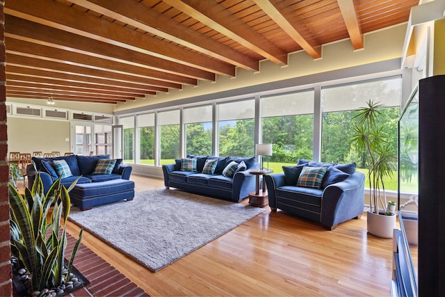 living room with light wood-type flooring and beam ceiling