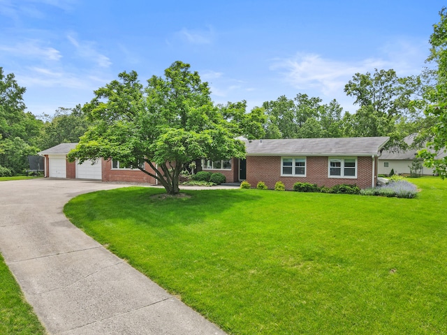 view of front of property with brick siding, a front lawn, and asphalt driveway