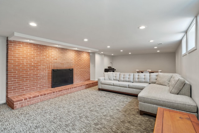 carpeted living area featuring recessed lighting and a fireplace