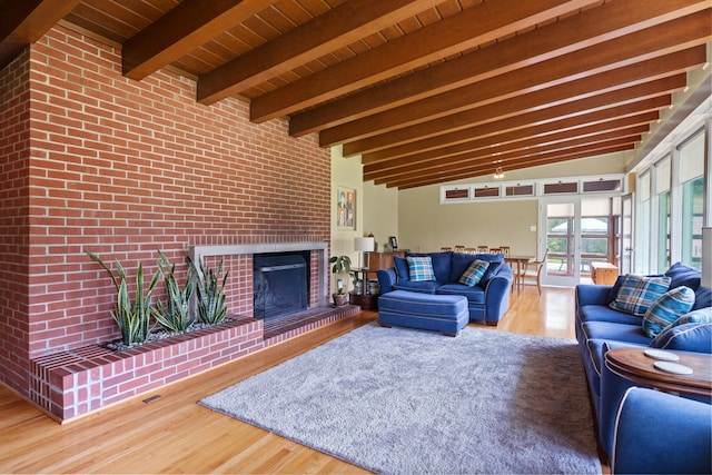 living room with wood finished floors, a fireplace, and wood ceiling