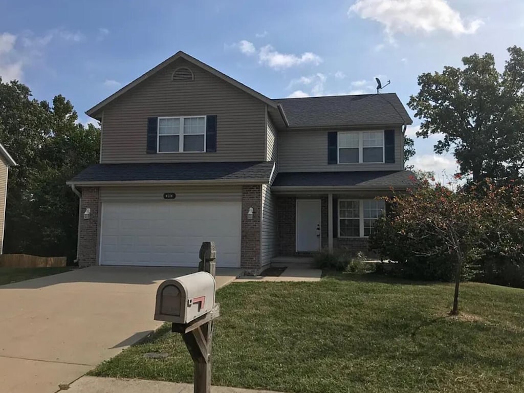 4114 Congo Cir, Columbia, MO 65202 - view of front of house featuring an attached garage, brick siding, concrete driveway, a front yard, and a shingled roof