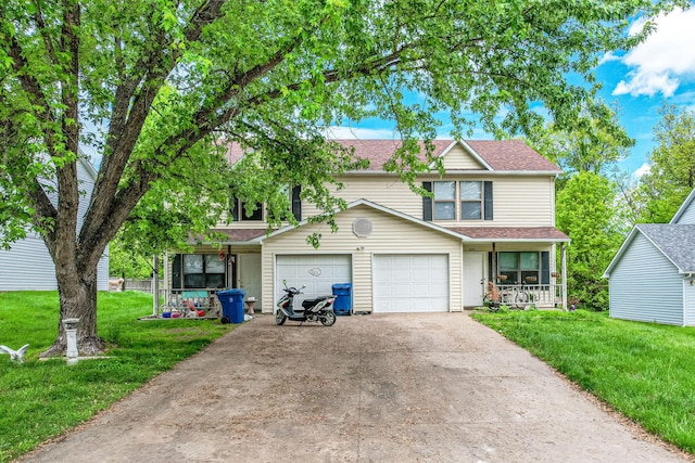 303 E Liberty Ln Unit A & B, Ashland, MO 63010 - view of front of home with a porch, a front lawn, concrete driveway, a shingled roof, and a garage