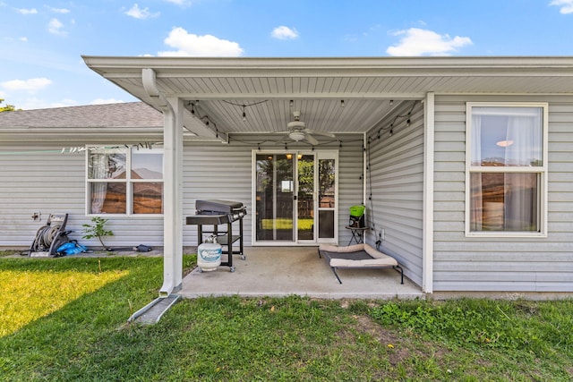 back of property featuring ceiling fan, a lawn, and a patio area