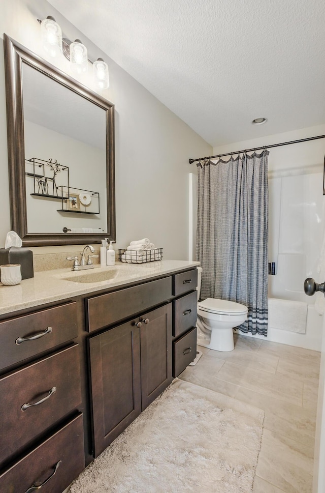 full bathroom with vanity, shower / bath combo with shower curtain, a textured ceiling, toilet, and tile patterned flooring