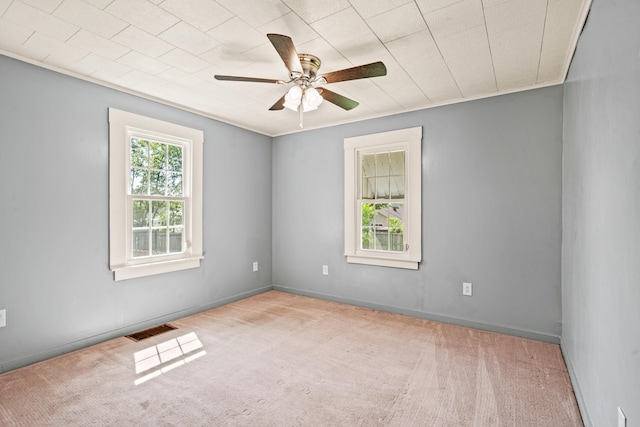spare room featuring carpet flooring and ceiling fan
