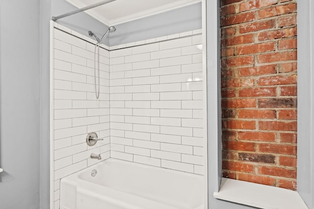 bathroom with crown molding,  shower combination, and brick wall