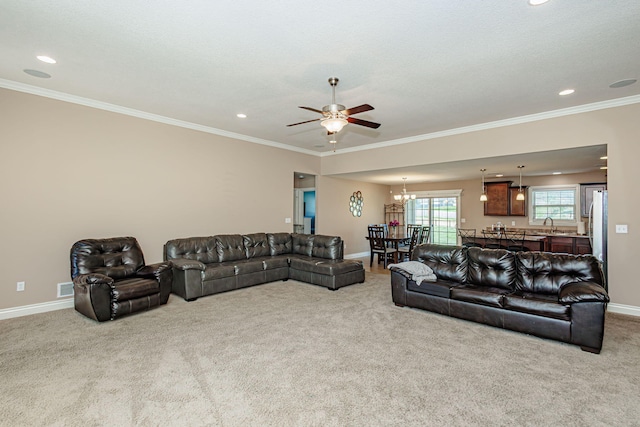 carpeted living room with a chandelier, a ceiling fan, crown molding, recessed lighting, and baseboards