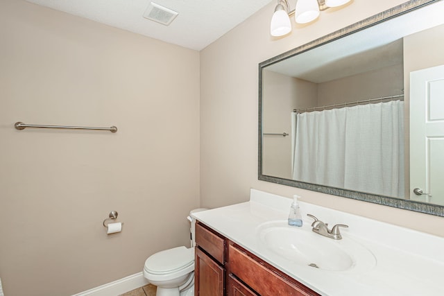 bathroom featuring toilet, vanity, baseboards, tile patterned floors, and a shower with shower curtain
