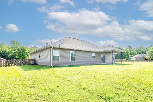 rear view of property with a ceiling fan, central AC, roof with shingles, and a patio