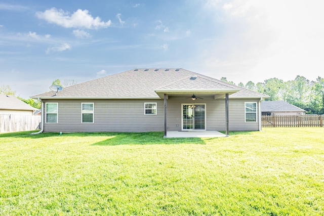rear view of property featuring a ceiling fan, a patio area, and a shingled roof