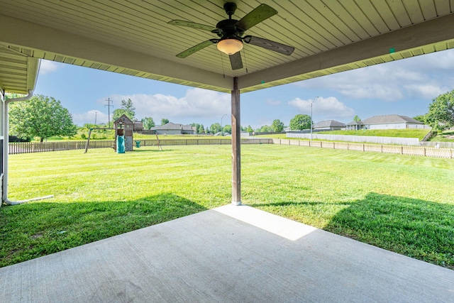 view of yard featuring a patio area, a playground, and ceiling fan
