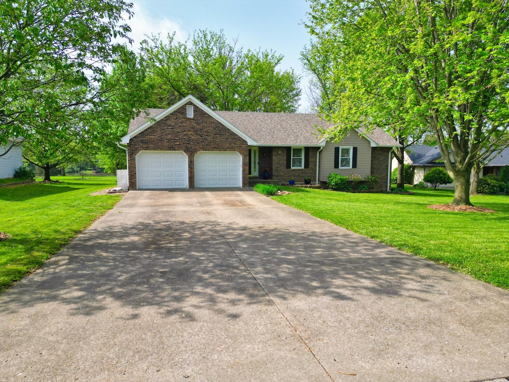 5680 Waterfront Dr N, Columbia, MO 65202 - single story home with a garage, brick siding, driveway, and a front lawn