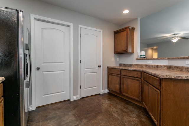 kitchen with stainless steel fridge, ceiling fan, brown cabinets, recessed lighting, and a peninsula