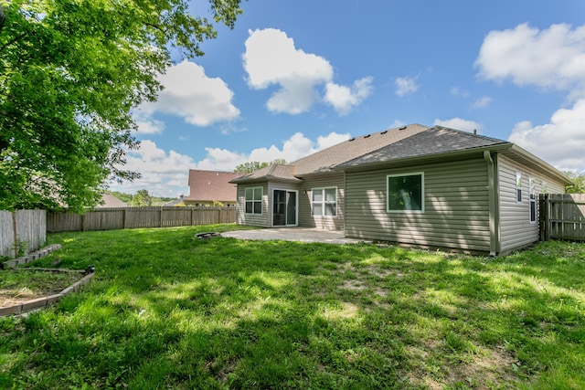 back of house featuring a patio area and roof with shingles