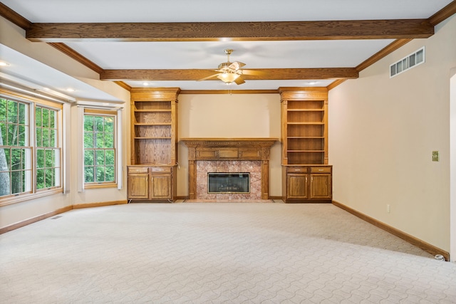 unfurnished living room with carpet flooring, baseboards, beamed ceiling, a high end fireplace, and ceiling fan