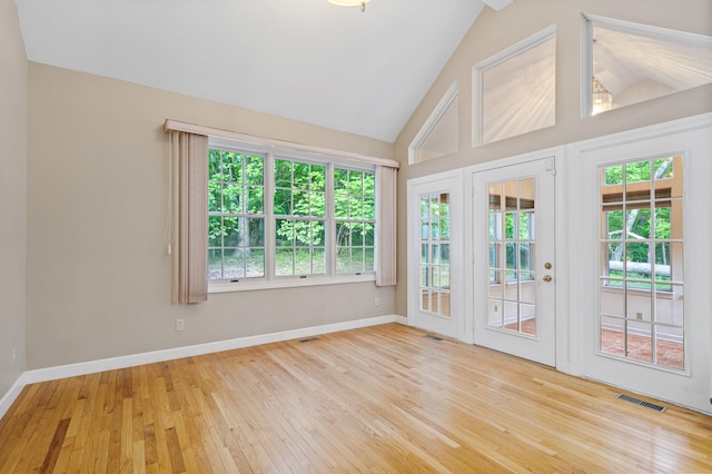 unfurnished sunroom with french doors, healthy amount of natural light, and lofted ceiling