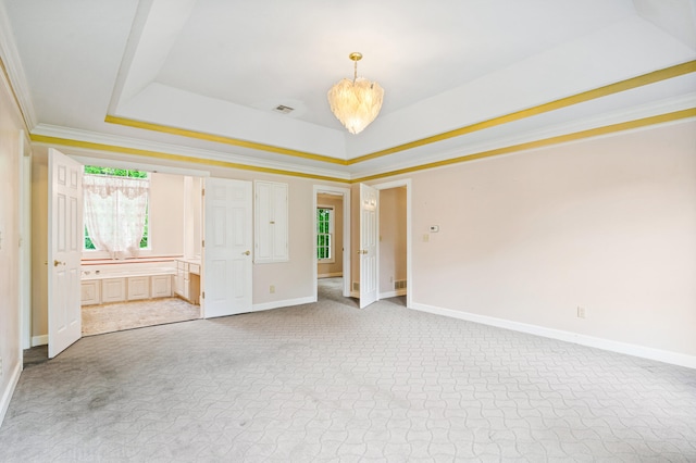 unfurnished bedroom featuring multiple windows, baseboards, carpet, a raised ceiling, and crown molding